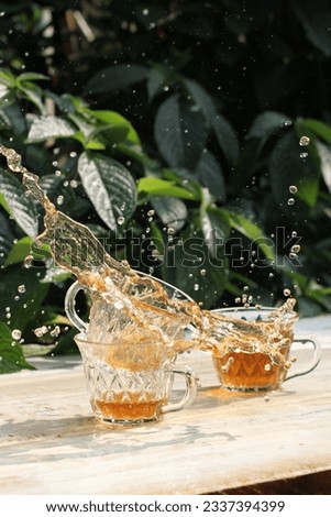 still life photography, water splash of cup of tea