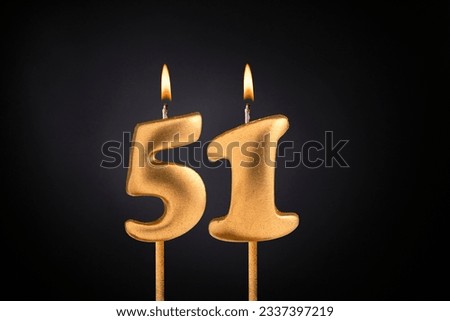 Golden candle 51 with flame - Birthday card on dark luxury background Royalty-Free Stock Photo #2337397219
