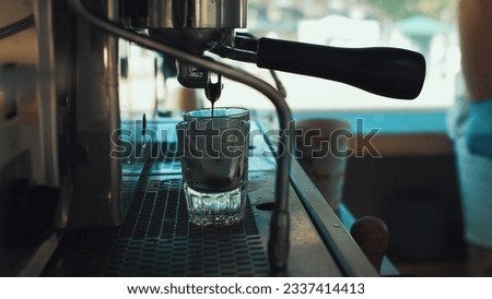 Coffee machine pouring coffee into shot glasses Royalty-Free Stock Photo #2337414413