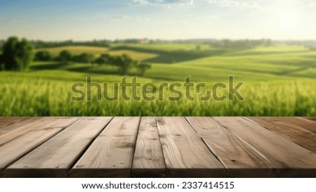 The empty wooden brown table top with blur background of farmland and blue sky. Exuberant image. Royalty-Free Stock Photo #2337414515