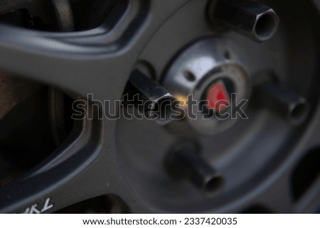 wheel bolts on a car in Indonesia with a blurry background