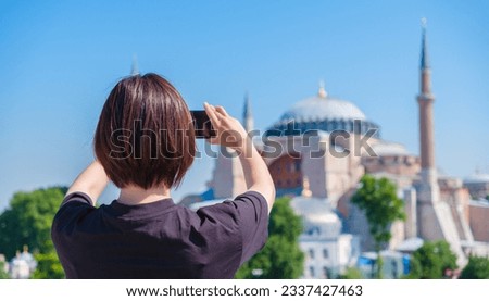 young asian woman taking photo at  the hagia sophia mosque in isntanbul