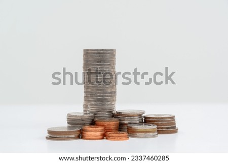 Growing amount of money Wealth and Growth Towers made out of gold and silver coins on a white background