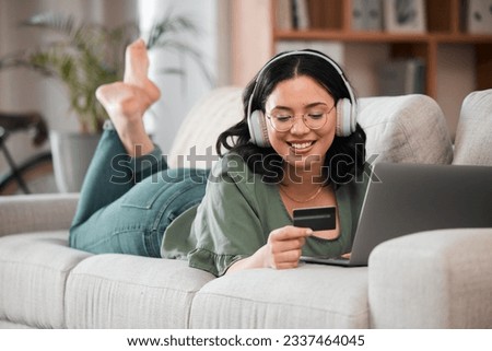 Woman, credit card and headphones on computer online shopping, e learning and fintech payment on sofa. Student or person relax with music subscription, banking services and home education on laptop Royalty-Free Stock Photo #2337464045