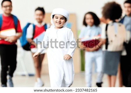 Selective focus on Arab student at school with students and classmates in diverse origins such as Africa, Asian, South America and other origin ideal for diversity concept Royalty-Free Stock Photo #2337482165