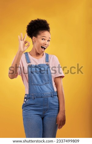 Portrait, okay and hand gesture with an excited black woman in studio on a yellow background. Smile, wow and perfect with a happy young female person showing a sign of support, feedback or review