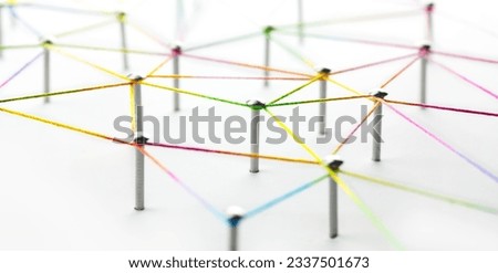 Networking. Linking entities. Network, social media, SNS, internet communication abstract. Web of red, orange yellow, green, blue, and purple connections on white background. Shallow DOF. 