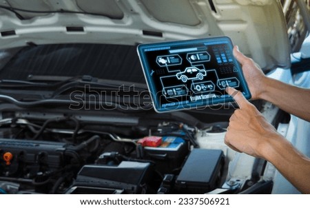 Smart Car Service Diagnostics Software concept.Mechanic using digital tablet Inspecting the Vehicle Royalty-Free Stock Photo #2337506921