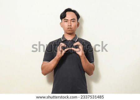 dancing gesture viral on social media Indonesian man wearing black shirt on isolated white background. broken hearted gesture. Asians dancing to "If We Ever Broke Up"