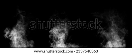 Close-up of steam or abstract white smog rising above. water droplets that can be seen that swirl beautifully from humidifier spray. Isolated on a black background Royalty-Free Stock Photo #2337540363