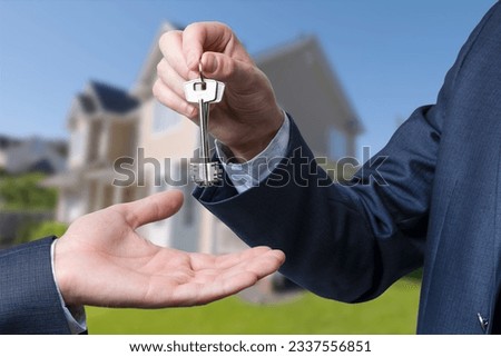 The real estate agent gives the keys to the meeting after the signing of the lease