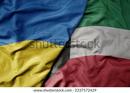 big waving national colorful flag of ukraine and national flag of kuwait . macro