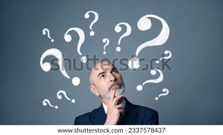 Thinking middle-aged white man in a suit. Facial expression. Royalty-Free Stock Photo #2337578437