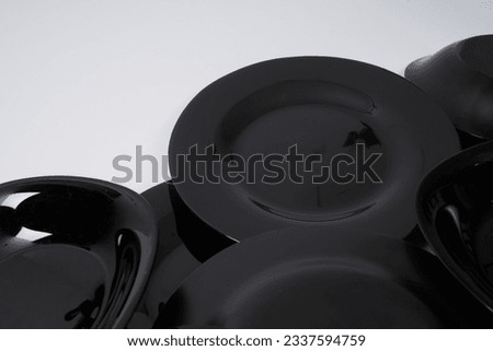  Black porcelain plates on a white background                               