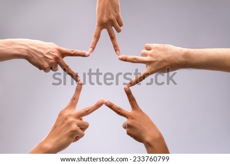 People forming star shape with their fingers