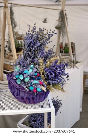 Decorative bouquet of lavender flowers. Ornaments made of lavender flowers placed in a straw basket and in a box.