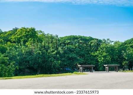 Garden bench with Green meadows with blue sky and clouds background, Landscape view of green grass on slope Scenic panoramic view on a beautiful sunny day,japanese picture concept.