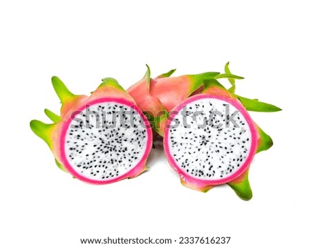 Juicy pink dragon fruit with white flesh and black seeds lies on a white background.