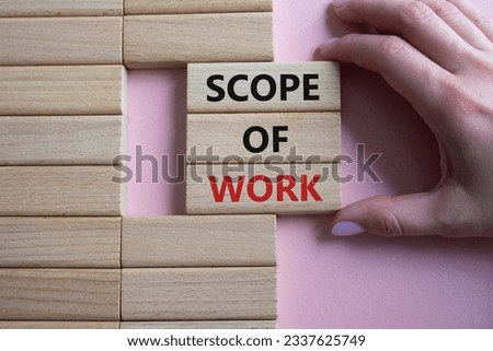 Scope of Work symbol. Concept words Scope of Work on wooden blocks. Businessman hand. Beautiful pink background. Business and Scope of Work concept. Copy space. Conceptual word