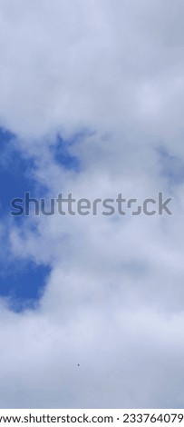 As the warm sun caresses the sky, these ethereal clouds drift lazily, like cotton candy dreams.  Royalty-Free Stock Photo #2337640797