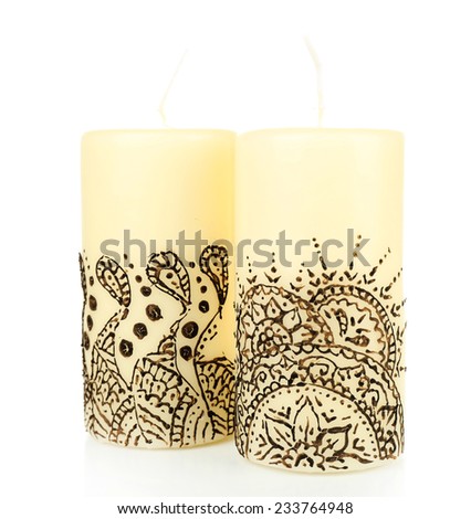 Beautiful candles with mehendi, isolated on white