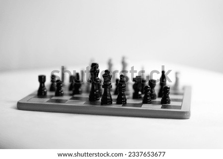 Two chess teams one in front of other on the chessboard. white background. High quality photo