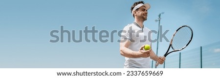 banner, cheerful tennis player in visor cap holding racket and ball on court, fitness and motivation