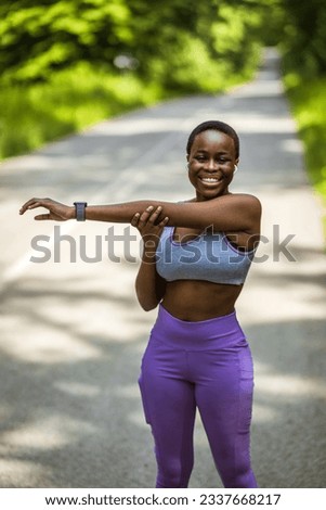 Active and fit young woman stretching her arms while exercising outdoors. Determined african american athlete doing a warmup for body to prepare for refreshing cardio workout or run and prevent injury