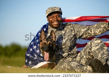 Pride of the USA. Soldier and military dog covered with American national flag celebrating Independence day. Royalty-Free Stock Photo #2337671227