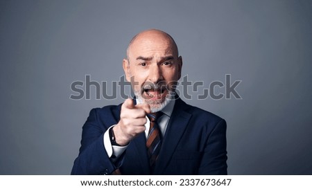 Middle-aged white man in a suit getting angry. Facial expression. Royalty-Free Stock Photo #2337673647