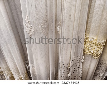 The fabric is tulle, chiffon and transparent white curtains. Abstract background, texture, pattern. Space for text and copy space