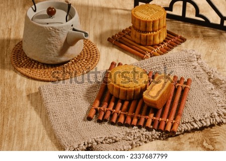 Moon Cake Mid Autumn Festival with teapot on wooden background ,chinese style photograph Royalty-Free Stock Photo #2337687799