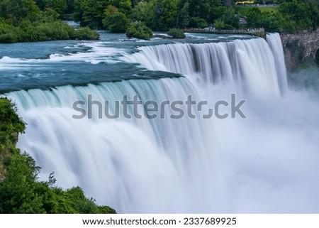 A long exposure photo of the American - Canadian waterfalls Niagara Falls in the evening.