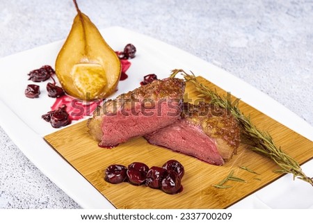 Duck breast with cherry jam and pear. Roast duck breast with  cherry sauce