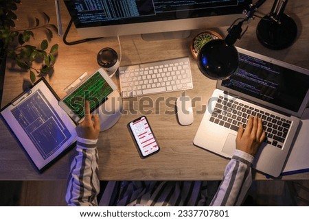 Female programmer working in office at night, top view