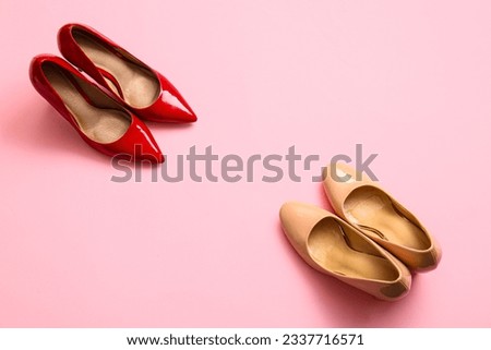 Fashionable high heeled shoes on pink background Royalty-Free Stock Photo #2337716571