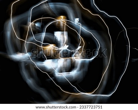 A photo of an irregularly rotating light showing clear lines of light and blurry lines of light