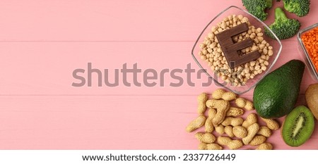 Healthy products rich in vitamin E on pink wooden background with space for text Royalty-Free Stock Photo #2337726449