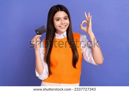 Photo of young teenager girl showing okey sign hold debit payment wireless card alright good job isolated on violet color background