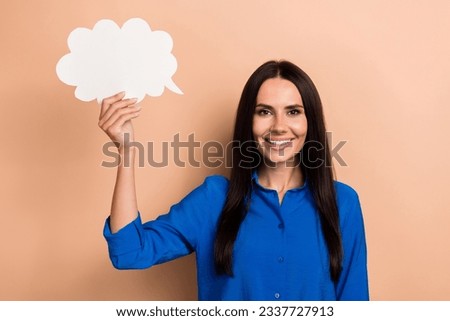 Photo of gorgeous pretty lady wear stylish clothes hand hold white bubble paper card empty space offer isolated on beige color background