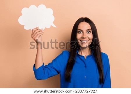 Photo of cheerful excited lady wear blue trendy clothes hand hold empty space feedback comment isolated on beige color background
