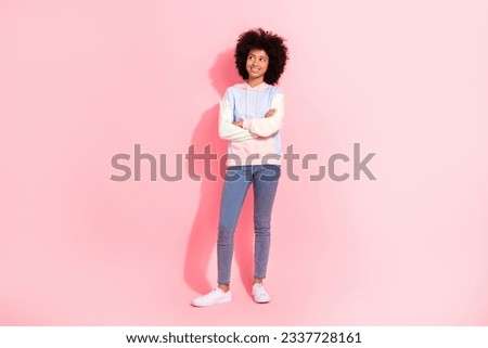 Full length photo of funky dreamy little child dressed hoodie arms crossed looking empty space isolated pink color background