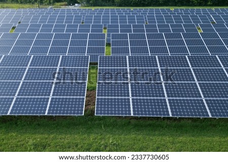 Solar panels on a field of green grass Royalty-Free Stock Photo #2337730605