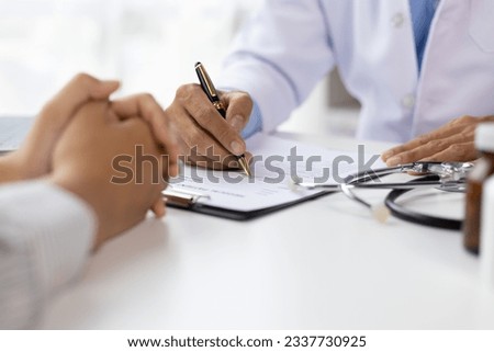 Doctor diagnosing a woman's illness in a hospital examination room, disease treatment from specialists. Medical treatment and health consultation. General health checkups and women's health problems. Royalty-Free Stock Photo #2337730925