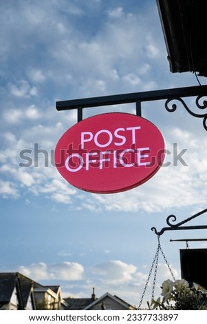 An old fashioned Post Office sign hanging outside a main street Post Office or traditional sub post office with copy space Royalty-Free Stock Photo #2337733897