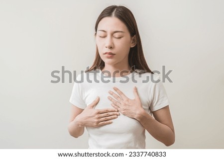 Acid reflux disease, suffer asian young woman have symptom gastroesophageal, esophageal, stomach ache and heartburn pain hand on chest from digestion problem after eat food, Healthcare medical concept Royalty-Free Stock Photo #2337740833