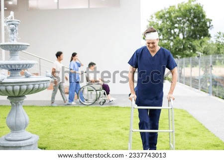 Patient using mobility walker in garden at sanatorium center