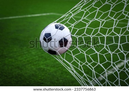 soccer ball on goal with net background, football player shoot a leather foot ball for make a score