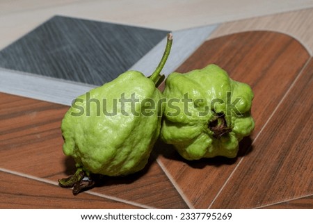 Guava fruit with leaf on a wooden background, Guava fruit on the brown wooden table