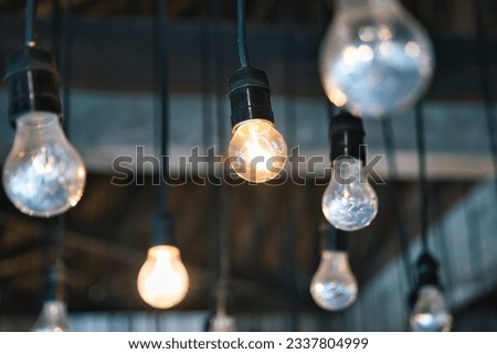 Light bulbs hanging from the ceiling. 
Idea finding symbol picture. Multiple light bulbs. Brainstorming, invention. creativity, ideation, and solutions. Symbol image for a creative workshop format.